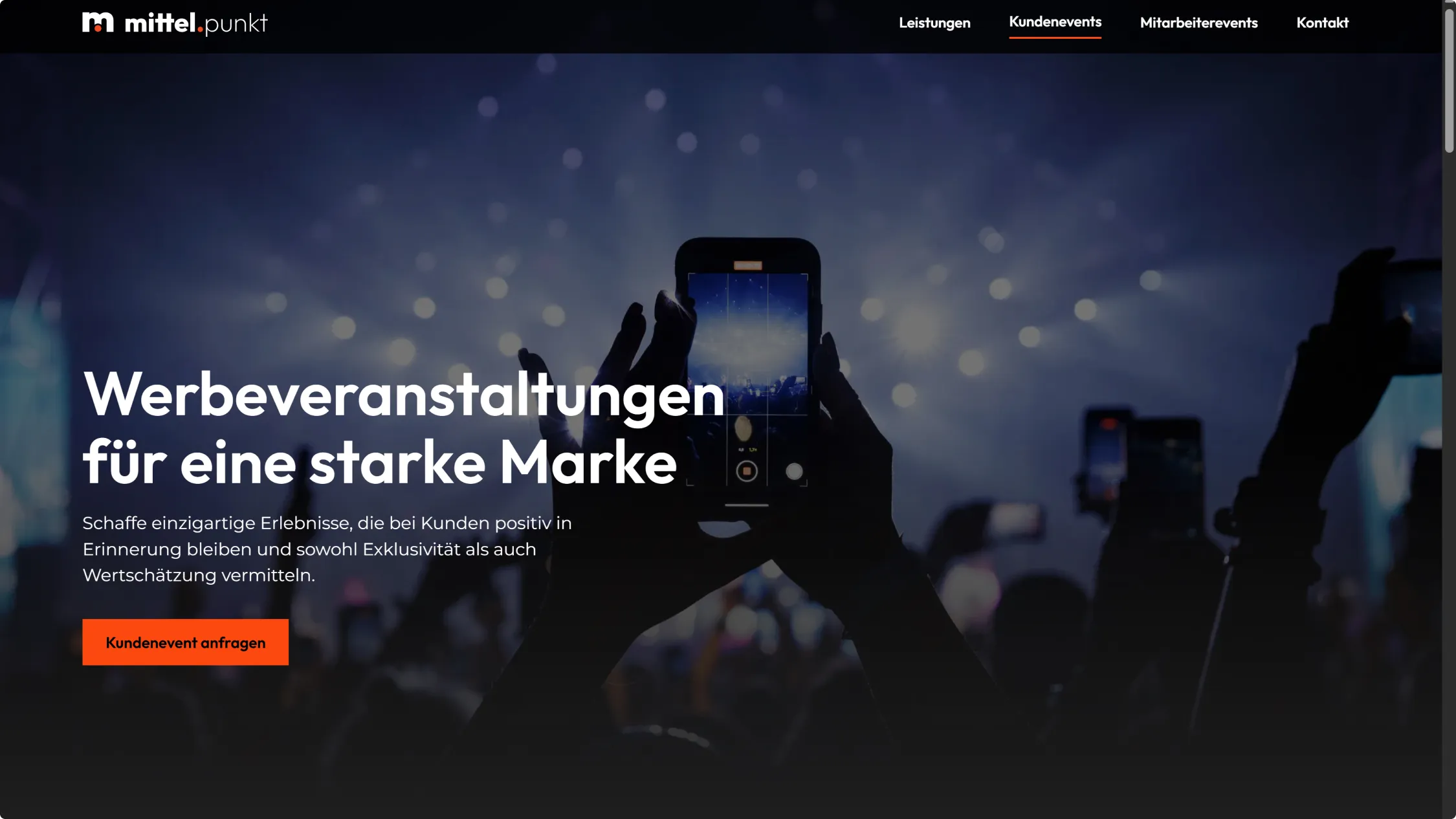 text on top of a picture that shows a person holding a phone in front of a stage